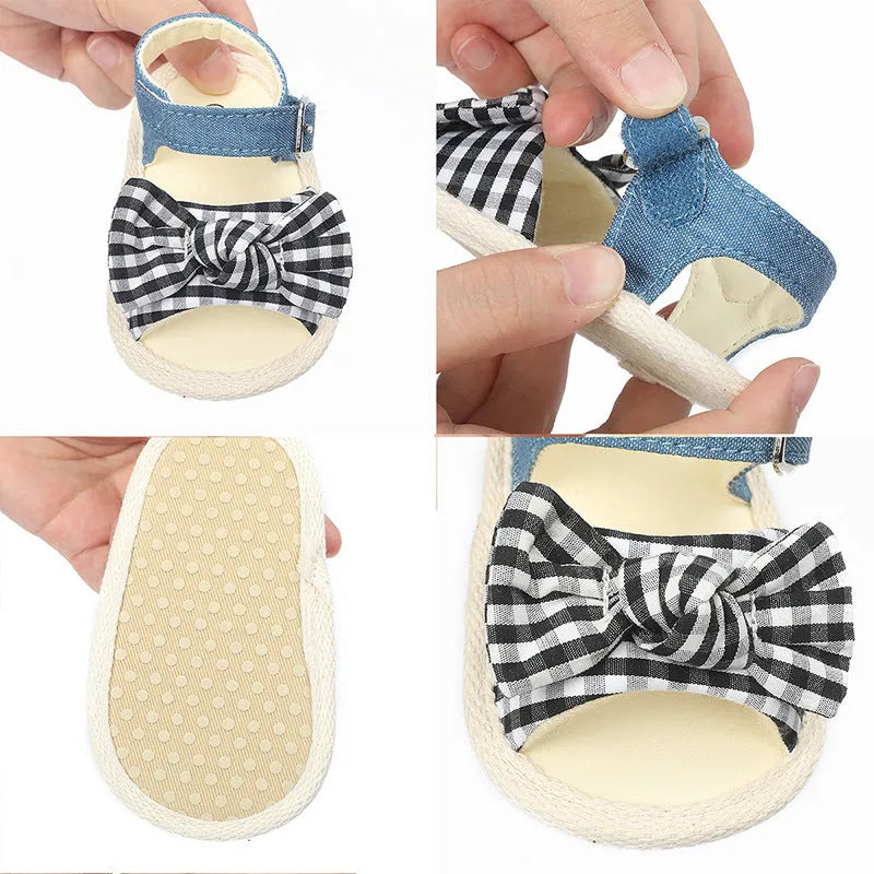 White and black low tube baby shoes with Velcro strap closure for toddlers.