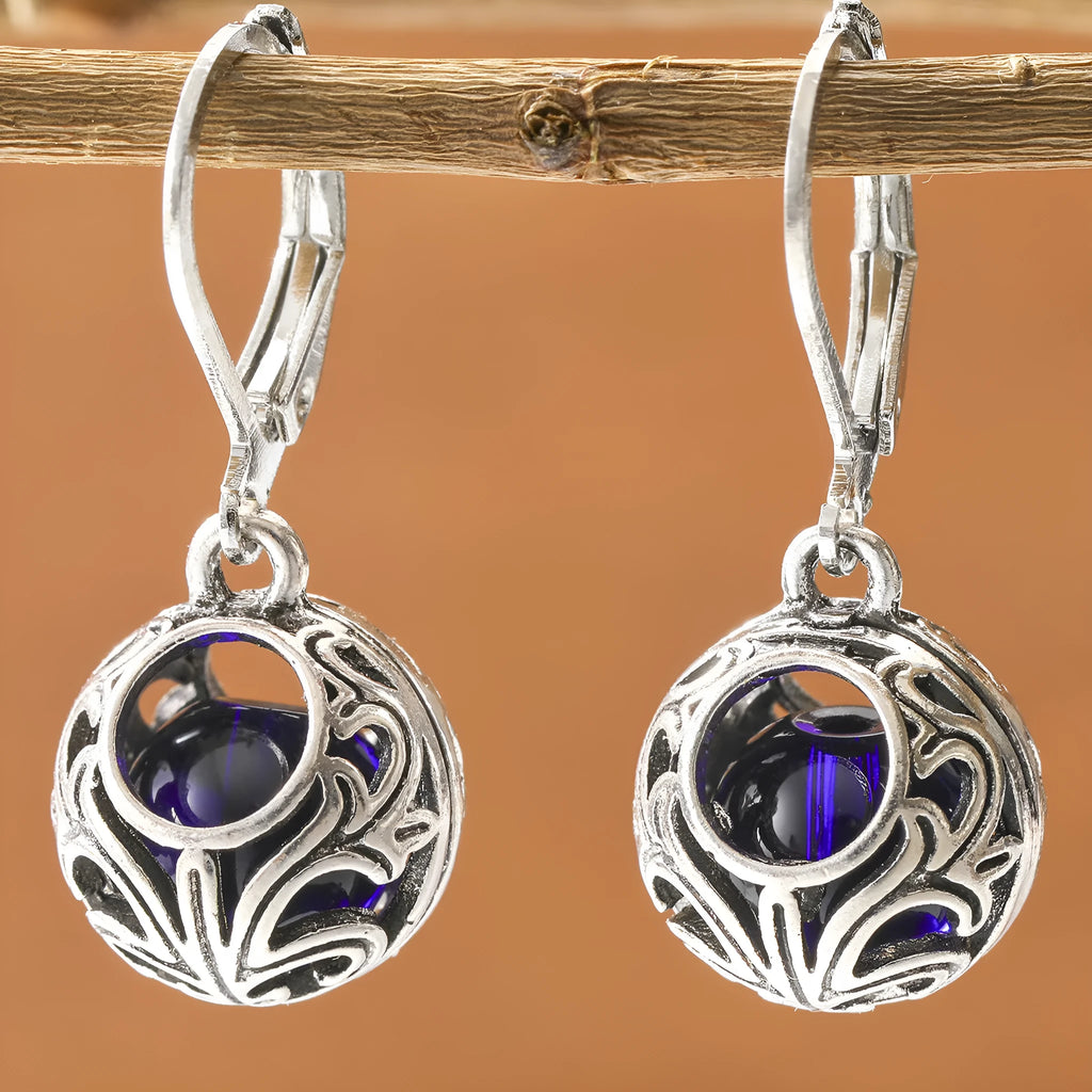 Silver geometric earrings with blue gemstone pendants and hollow engraving details