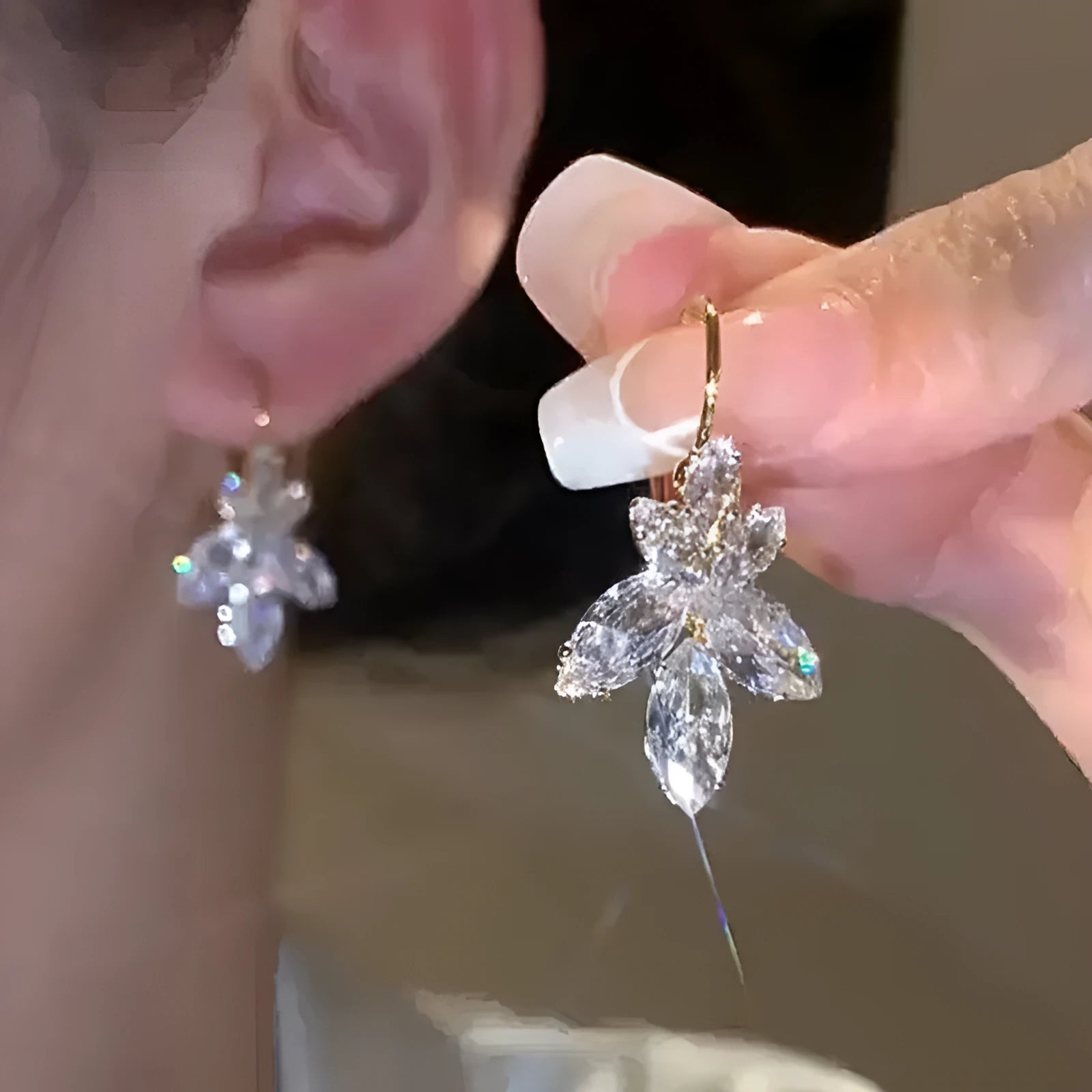 Platinum colour leaf-shaped earrings with zircon inlay creating shiny reflective surfaces