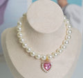 Cat collar with plastic heart charm in blue, shown alongside pink, green, purple, transparent and sapphire blue colour options