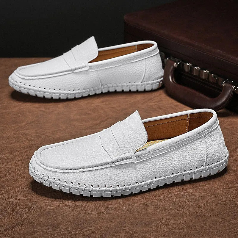 Men's casual leather slip-on shoes with hand-stitched bottom, square heel, and rubber sole in a neutral colour.