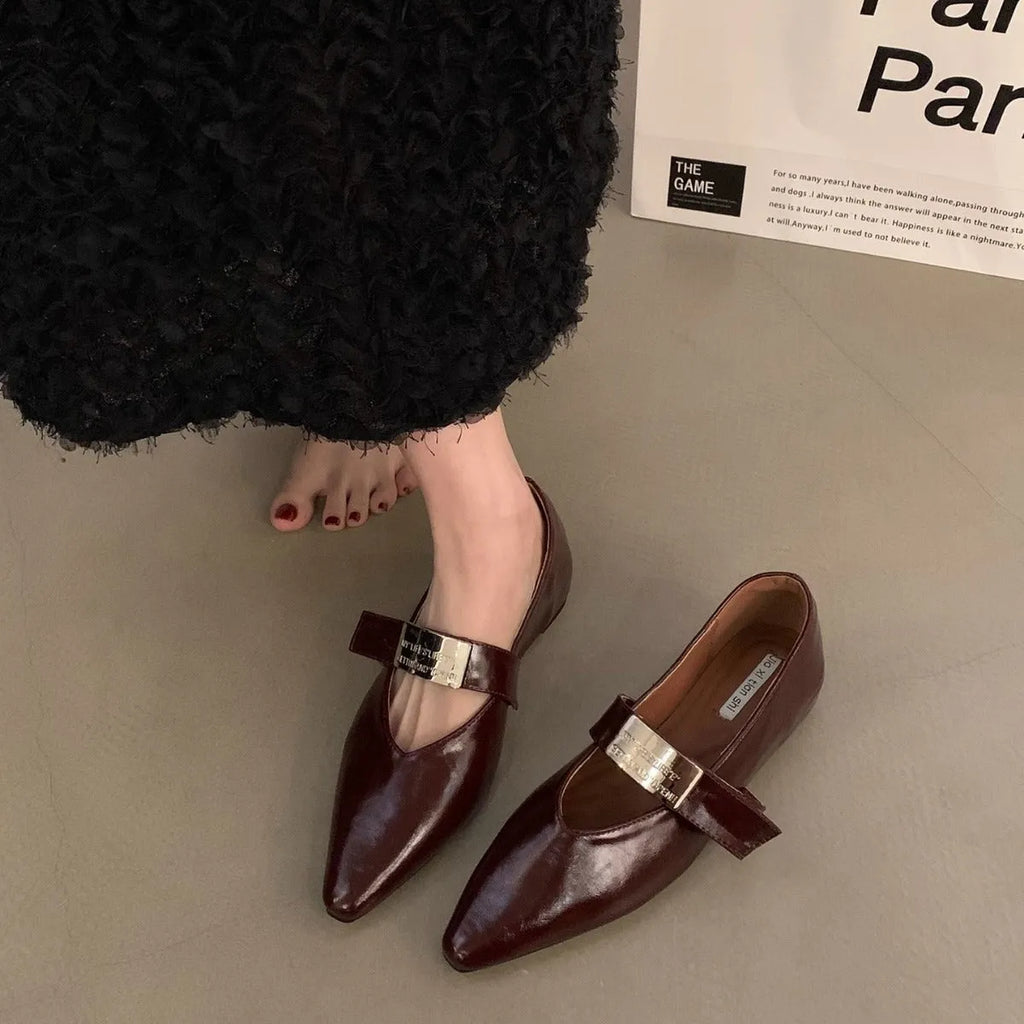 Women's black pointed toe Mary Jane pumps with buckle closure and low block heel