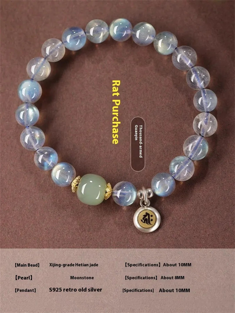 Close-up of a women's bracelet with 8mm moonstone beads and an electroplated Kwan-yin mouse charm.