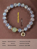 Close-up of a women's bracelet with 8mm moonstone beads and an electroplated Kwan-yin mouse charm.