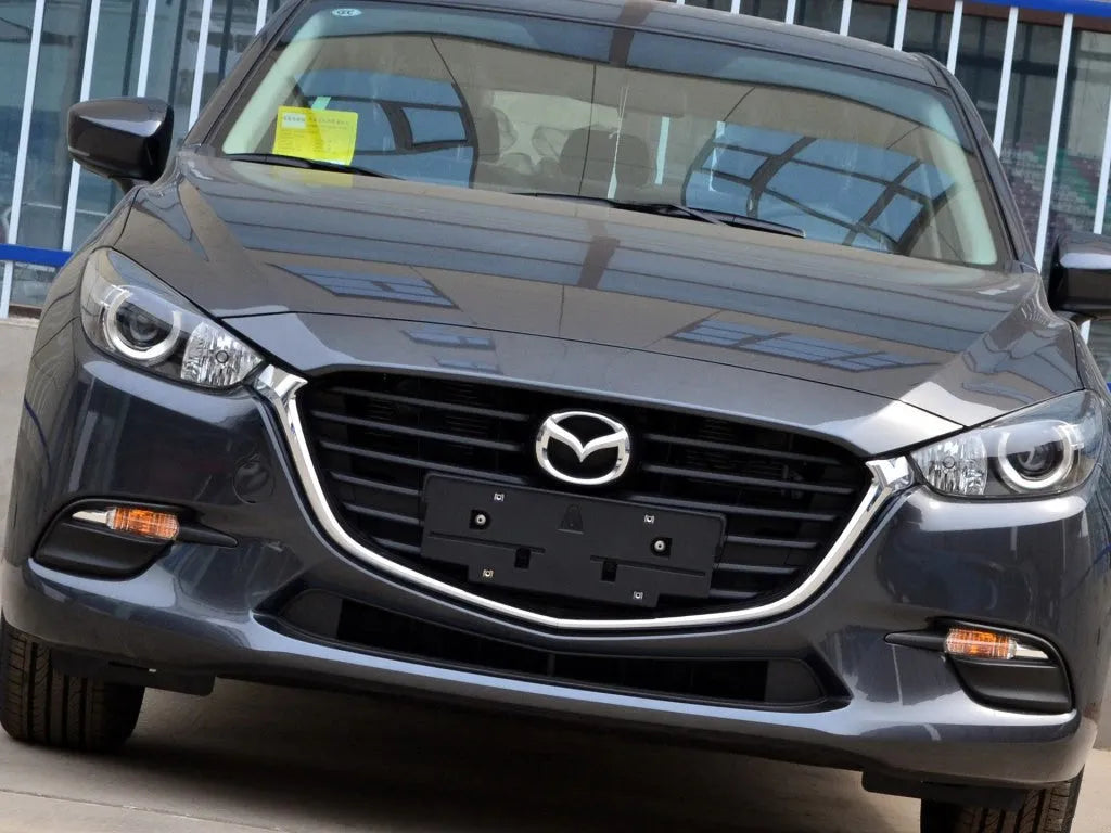 Mazda 3 Exela replacement headlamp cover with tube of snake glue adhesive.