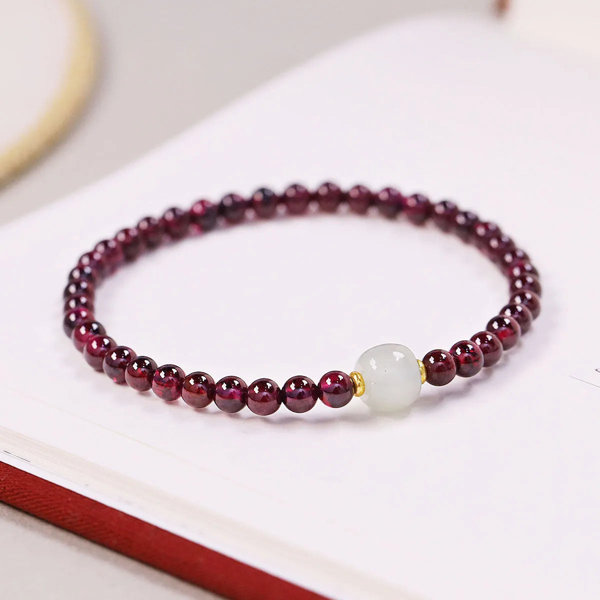Simple U-shaped natural garnet bracelet for women, shown in garnet and dream garnet colour options with 4mm and 6mm bead sizes.