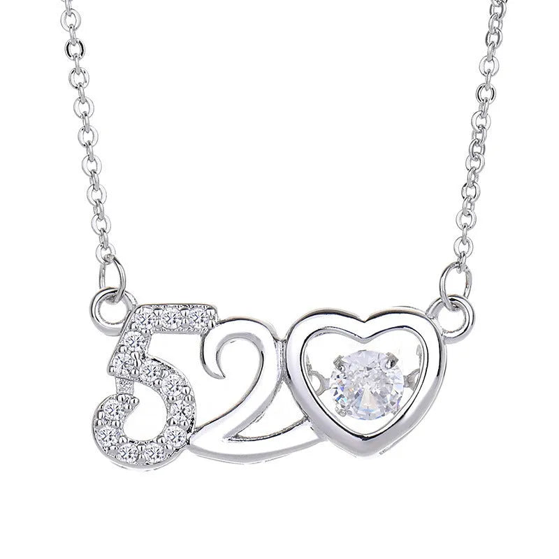 Women's sterling silver love heart necklace with crown and bow details on pendant