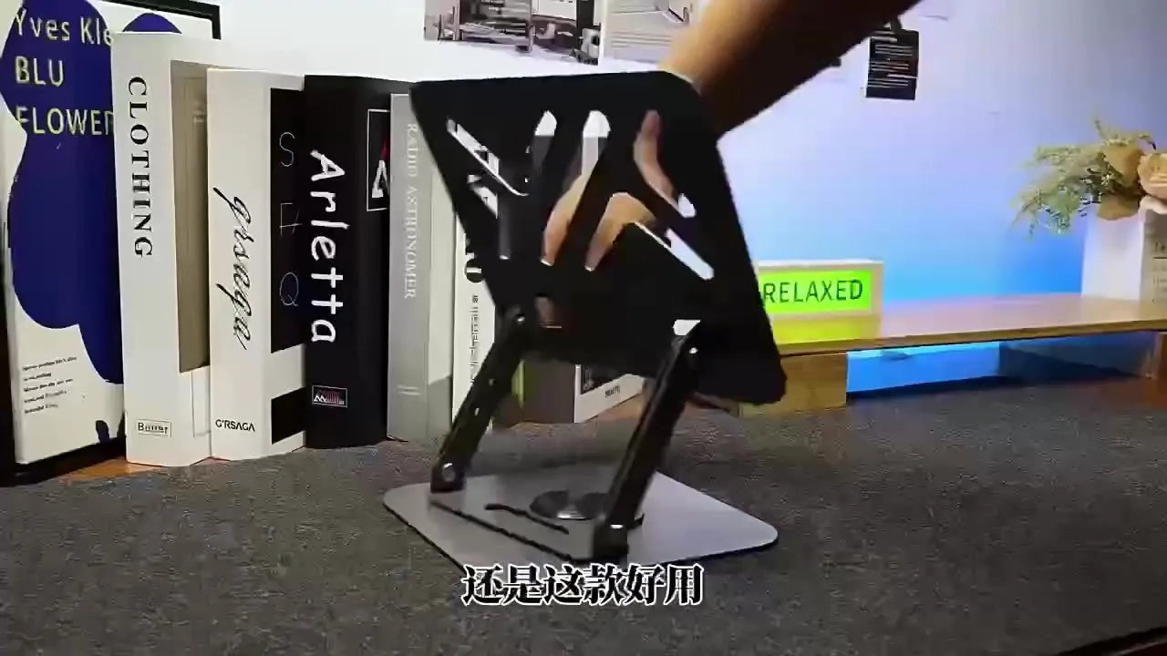 Black height-adjustable foldable laptop stand with heat dissipation grid, supporting a laptop on a desk