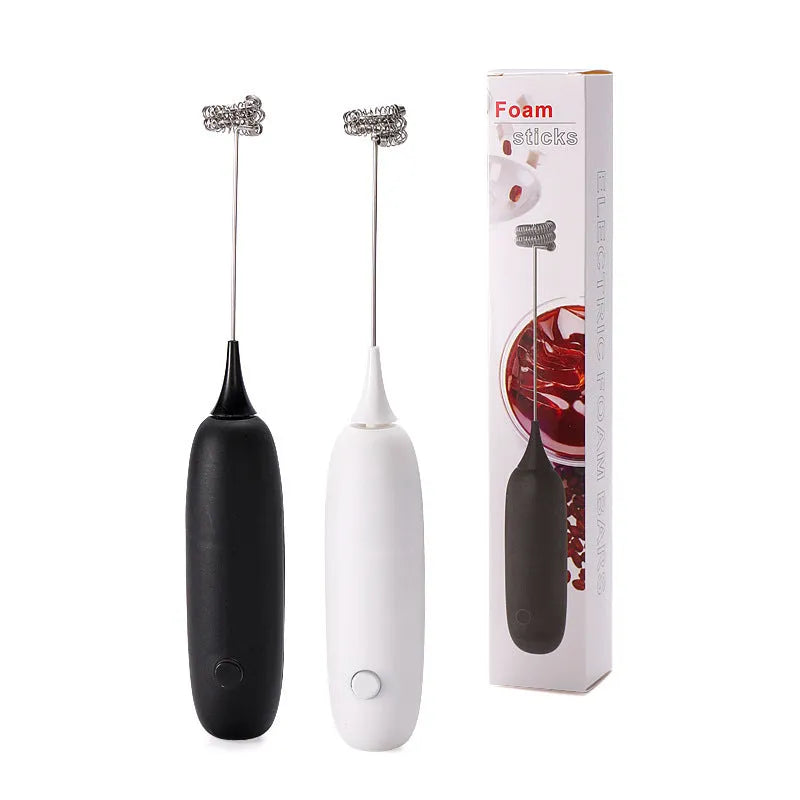 Electric hand-held milk frother blender in black and white colour options on a kitchen counter.
