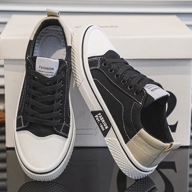 Men's low-top casual canvas skateboard shoes in blue with round toe and front lace-up closure.