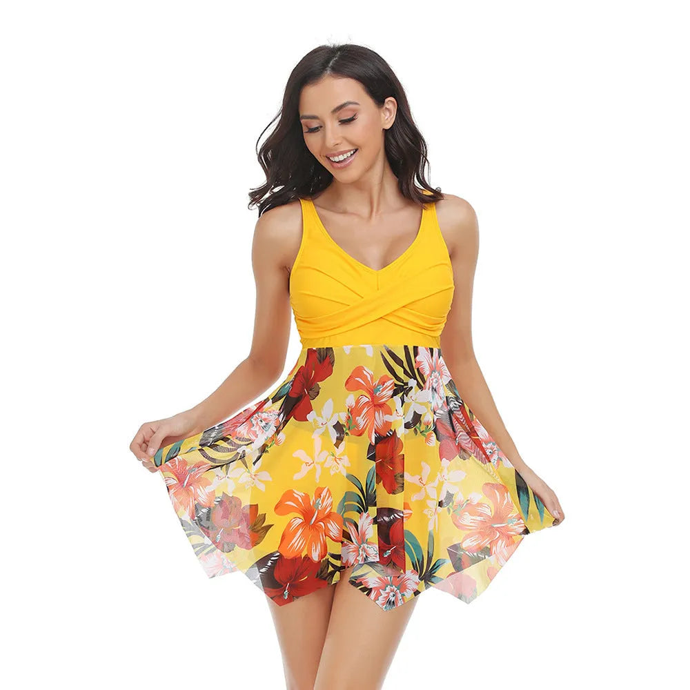 Women's one-piece swimsuit with a black tulle skirt overlay and split leg design on a mannequin.