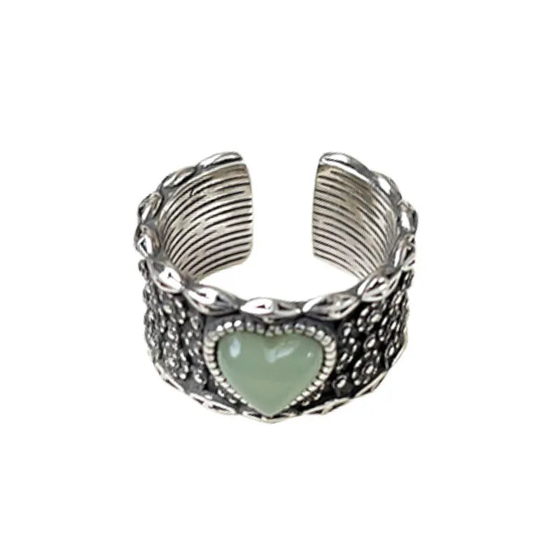 Retro wide-faced silver heart ring with adjustable opening on a white background.