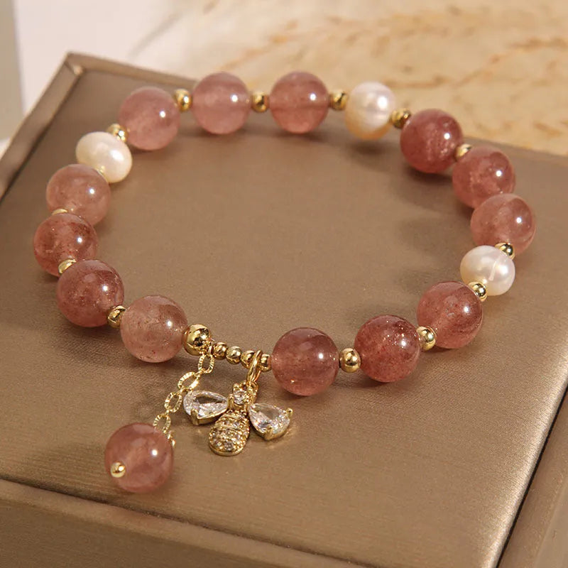 Women's bracelet with strawberry quartz beads, freshwater pearls, and metallic charms in Japanese Korean jewellery style