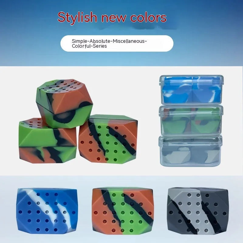 Two silicone camouflage-style facial muscle fitness balls for jaw training in transparent boxes.