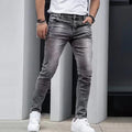 Men's black stretch skinny jeans showing high elasticity cotton-spandex fabric with zipper fly and straight leg cut