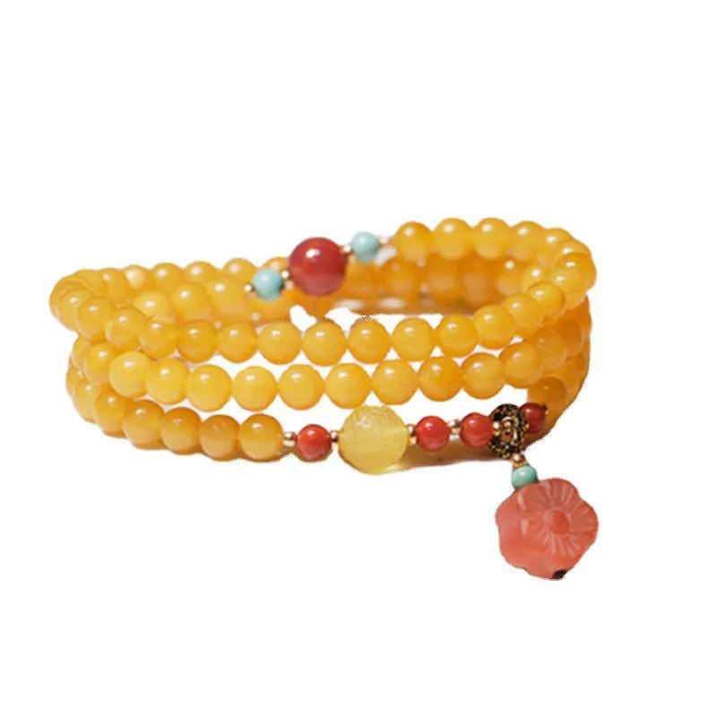 Yellow amber bracelet with 5mm round beads and an animal zodiac charm on a white background.