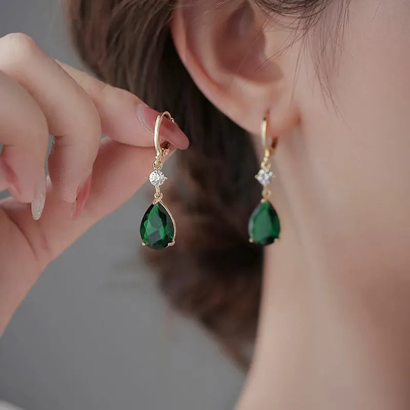 A pair of green geometric teardrop-shaped dangle earrings made from alloy.