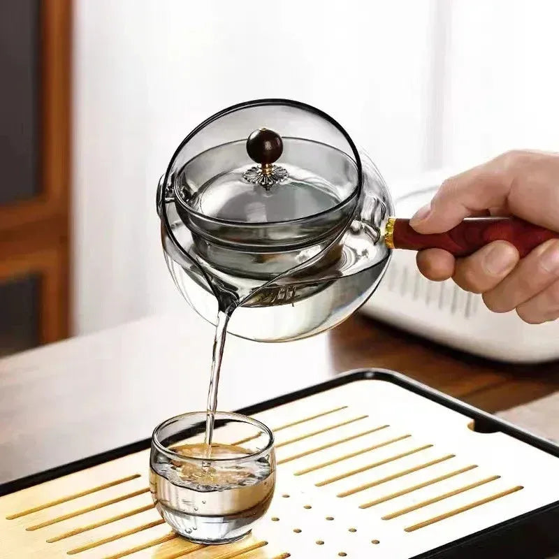 Semi-automatic rotary glass teapot with wooden handle and infuser, in grey and transparent colour options.