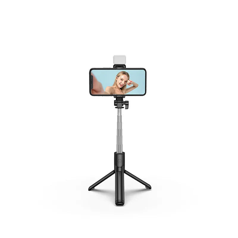 Black Bluetooth selfie stick with extended tripod legs holding a smartphone.