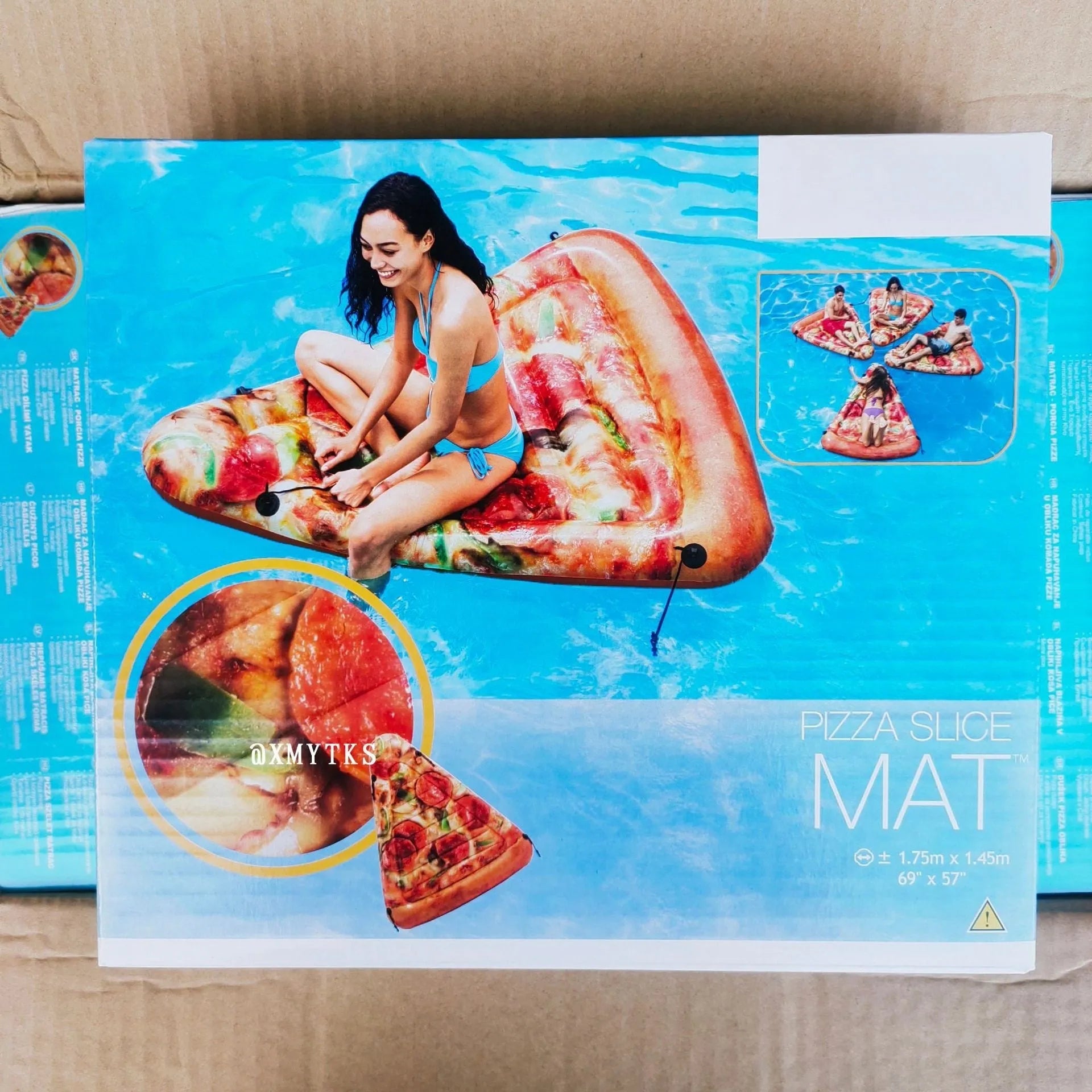 Large green and beige pizza-themed inflatable surfboard lounger floating on water
