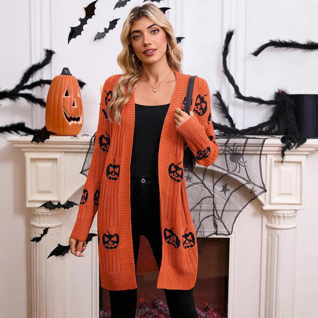 Women's black cardigan with orange pumpkin head jacquard knit pattern on the front.