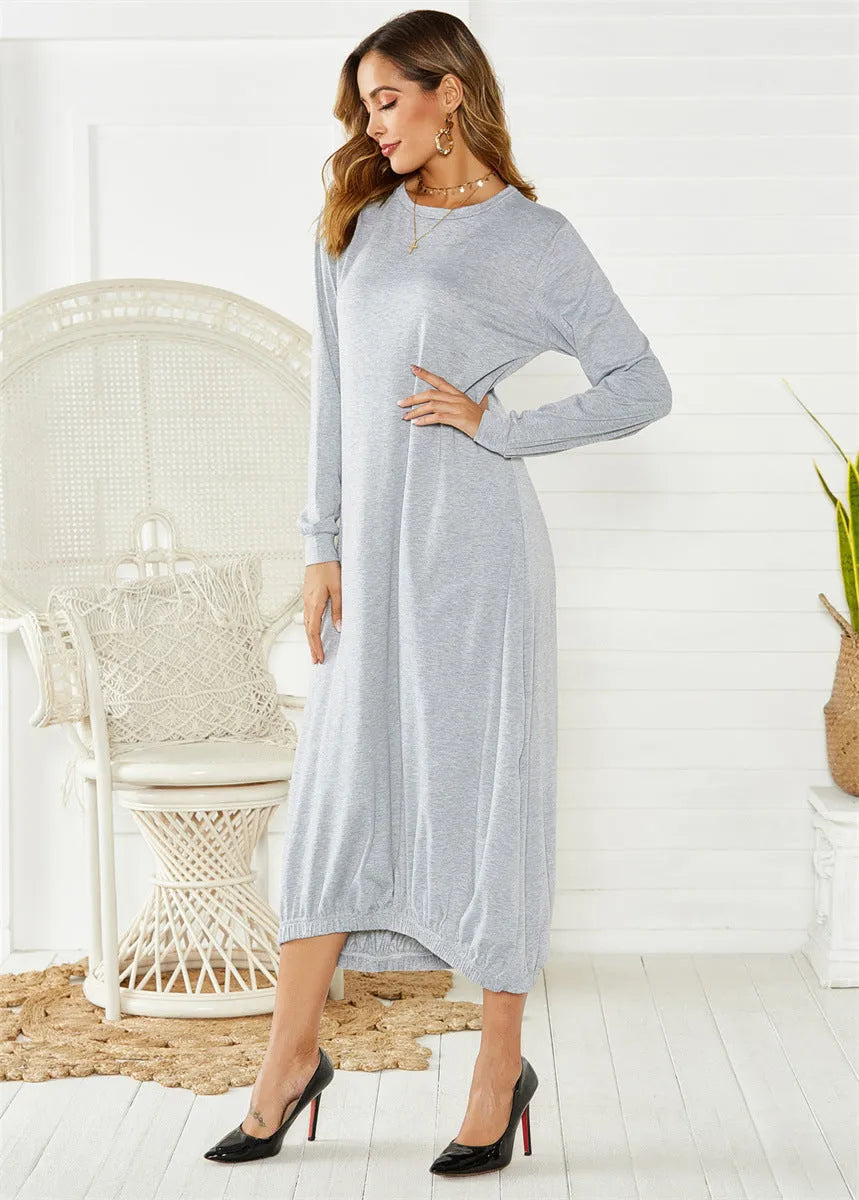A loose black lantern dress with a lace-up crew neck, showcasing its casual knitted pullover style.