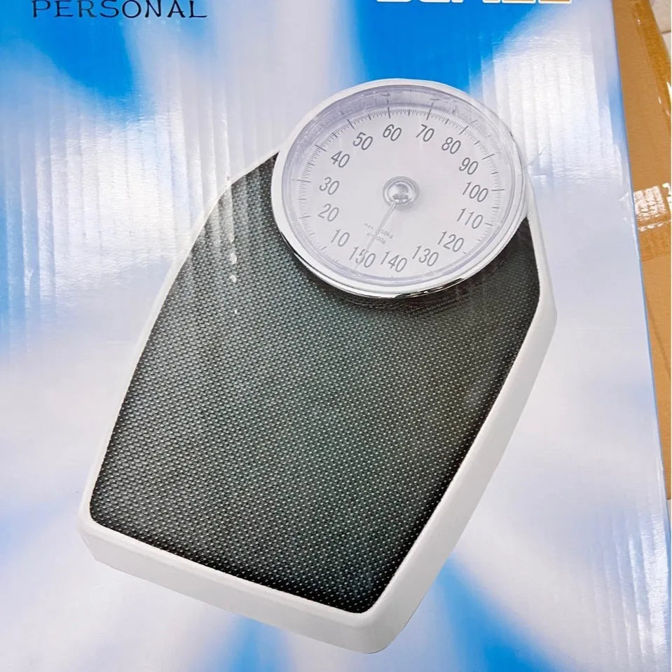 Black mechanical weight scale with large dial measuring 47x35x11cm