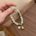 Women's white multi-layer beaded bracelet with rice-shaped and round beads in ethnic vintage style.