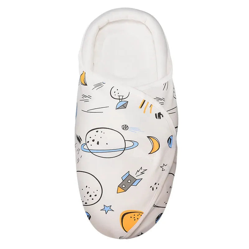 Cotton anti startle baby swaddle in a choice of colours including dinosaur and starry sky patterns.