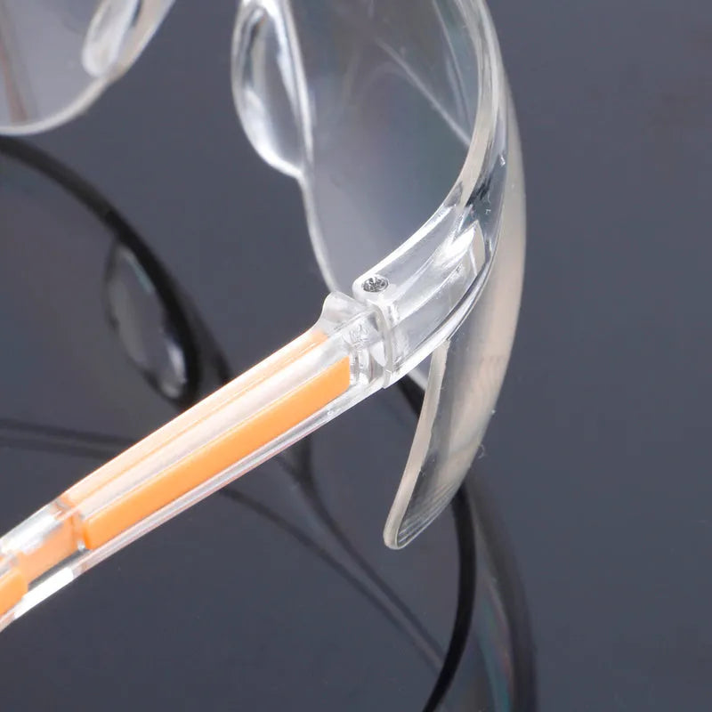 Transparent polycarbonate safety goggles with yellow lenses for eye protection.