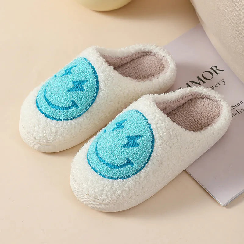 Women's plush slippers with cartoon love design, showing round toe and non-slip PVC sole.
