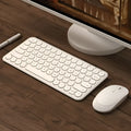 White ultra-thin wireless keyboard and mouse set on a desk.