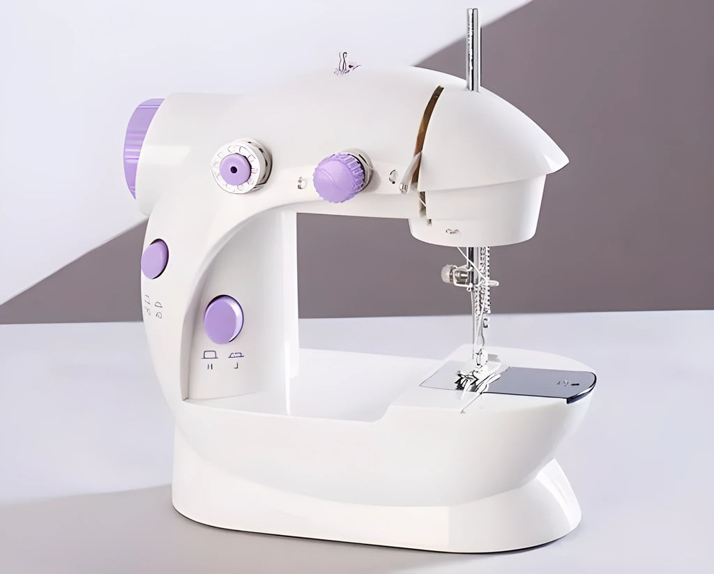 Miniature white and grey electric household sewing machine with thread spool and power cord.