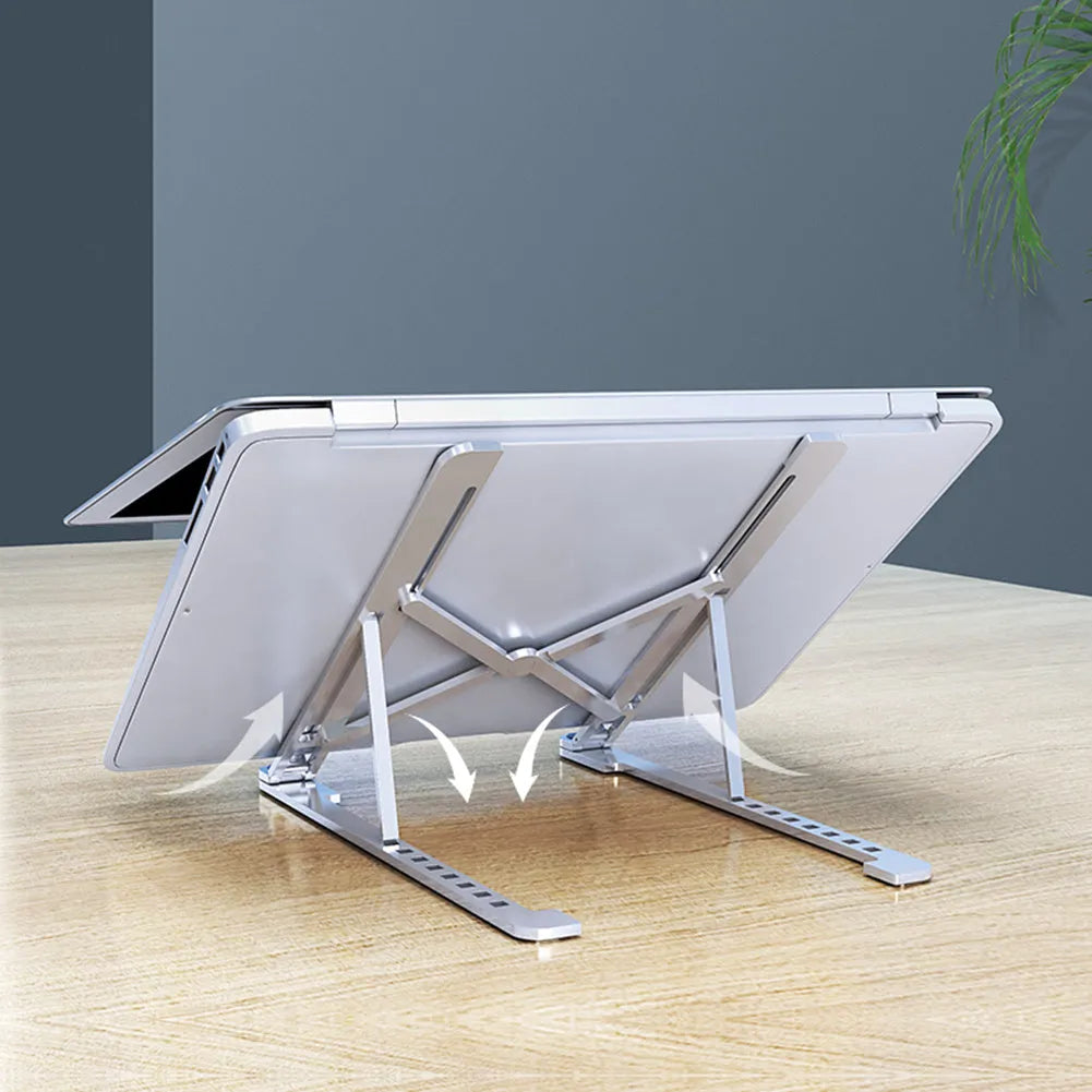 Foldable aluminium laptop stand in silver colour, shown adjusted to a height with a laptop on it