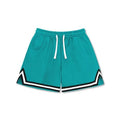 Man wearing loose grey polyester sports shorts with an elasticated waistband.