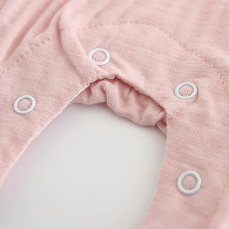 Pink 100% cotton embroidered jumpsuit for a baby girl, with long sleeves and single-breasted closure.
