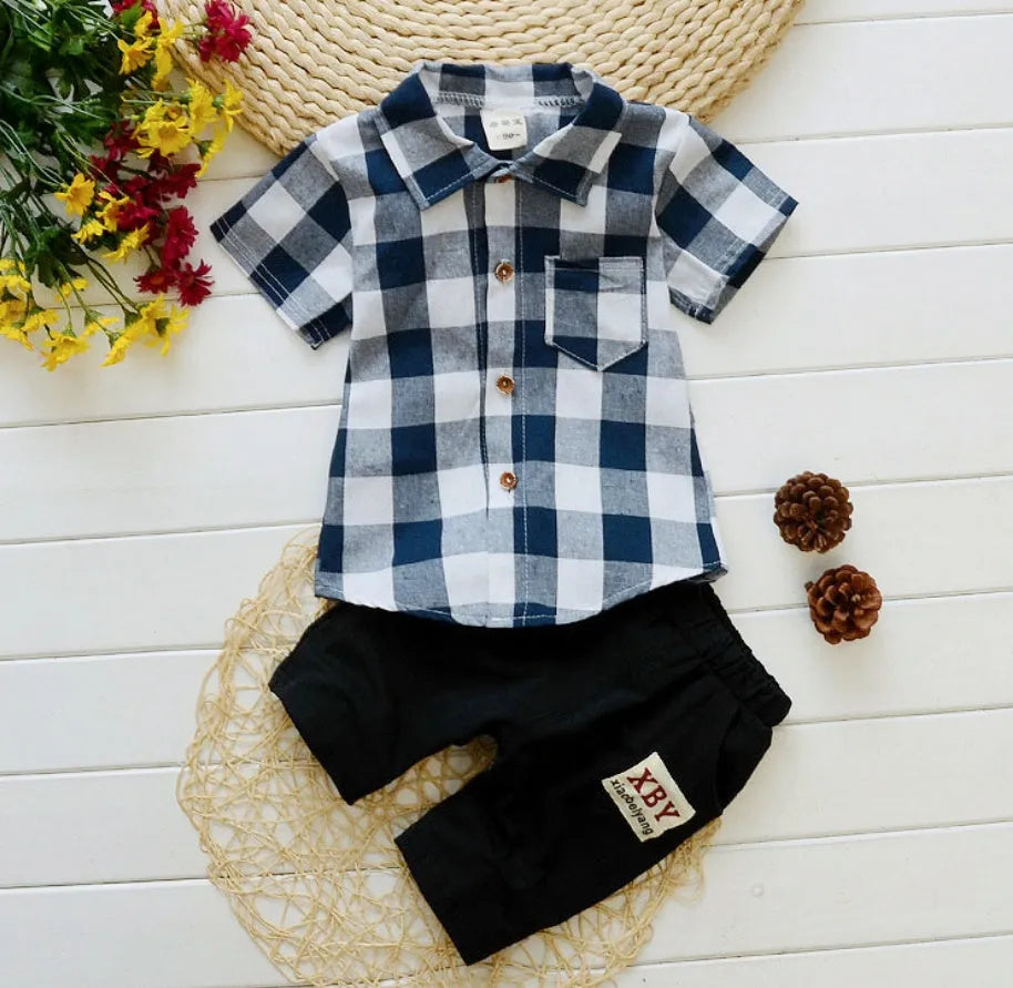 Baby boy wearing a blue crocodile print cotton short sleeve t-shirt and matching shorts summer outfit.