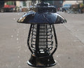 Black solar-powered electronic mosquito lamp with solar panel on top for outdoor garden use.