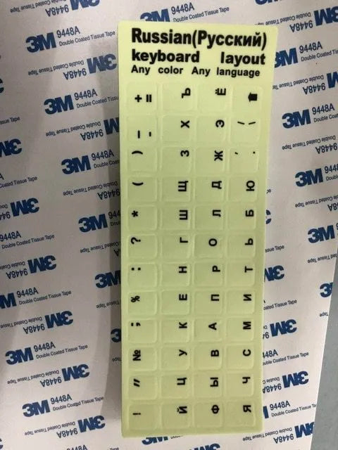 Yellow glowing keyboard stickers showing Arabic, Thai, Hebrew, French, Italian and German characters on PVC sheet