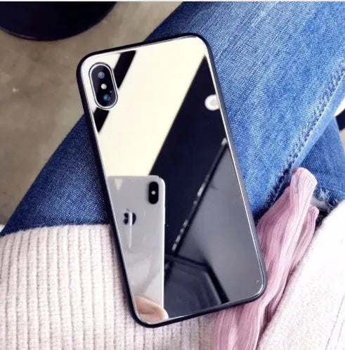 Black iPhone mirror phone case showing reflective surface on back, compatible with iPhone X and Plus models.
