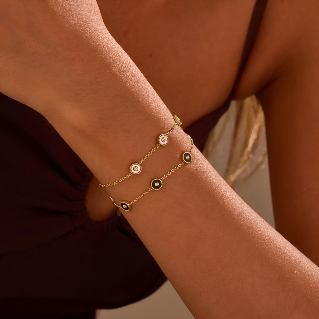 Geometric women's stainless steel bracelet with 18K gold electroplating alongside matching necklace