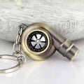 Metal whistle keychain with keyring in gold colour, front view on white background