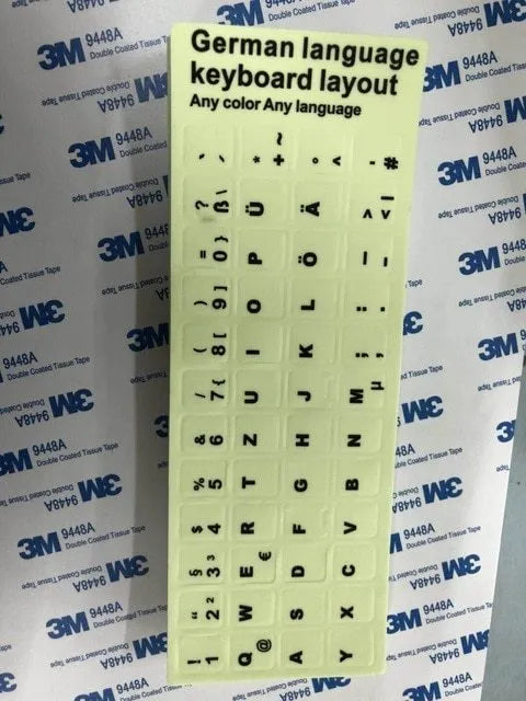 Yellow glowing keyboard stickers showing Arabic, Thai, Hebrew, French, Italian and German characters on PVC sheet