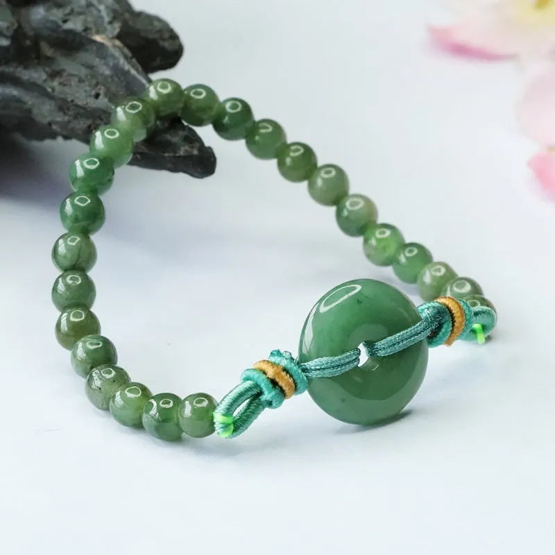 Oil green jade bracelet with star-shaped beads and a silver safety buckle clasp.