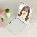 Folding LED pocket cosmetic mirror in black, blue, pink, and white, compact travel makeup mirror with built-in light.