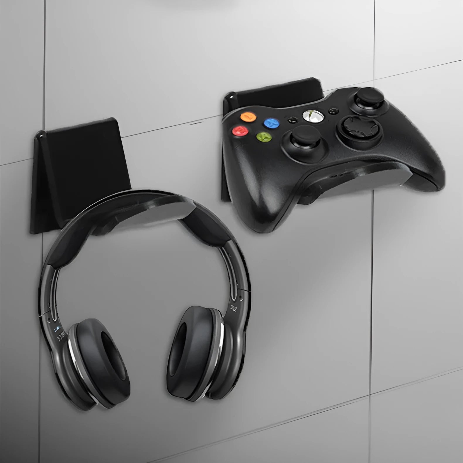 Universal game controller wall mount bracket in black plastic with gaming controller inserted
