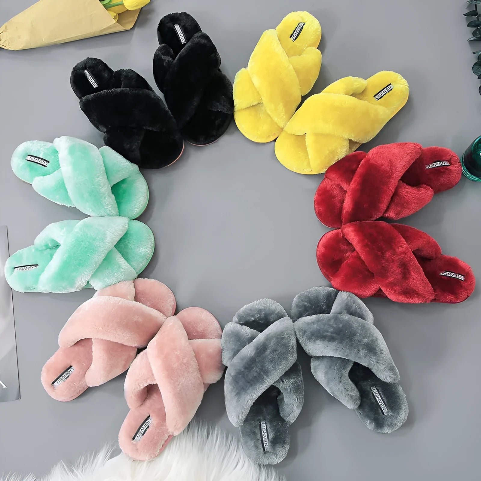 Cross open-toe fur slippers showing personalised toe design and patterned non-slip soles