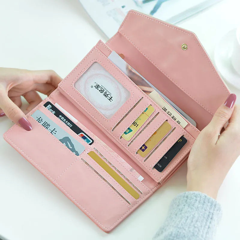 Three-fold black PU leather student wallet with a buckle closure and a leather clip, shown open to display multiple card slots.