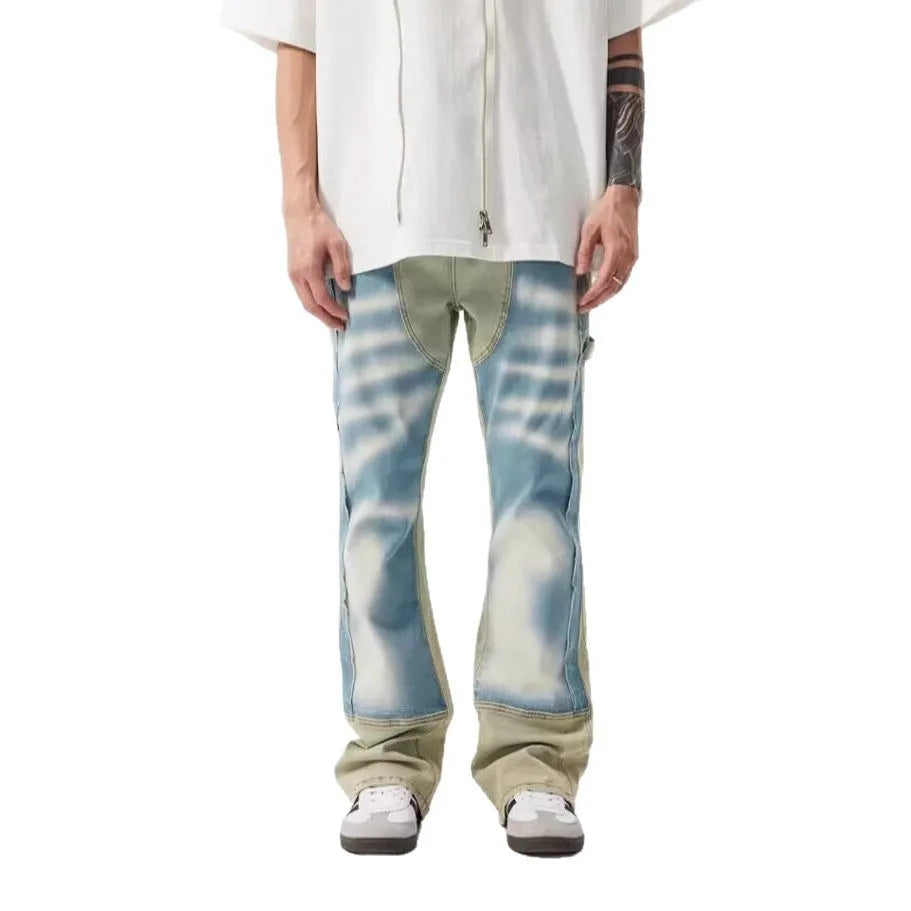 Yellow and blue retro patchwork jeans with splash-ink damaged design details on denim fabric