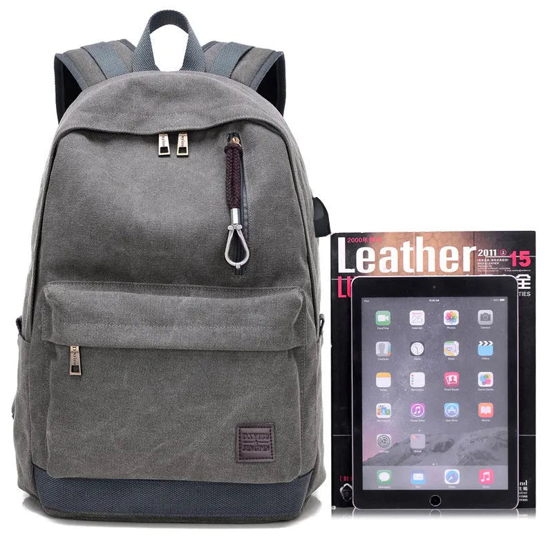 Canvas backpack in grey colour showing external USB port and multiple compartments.